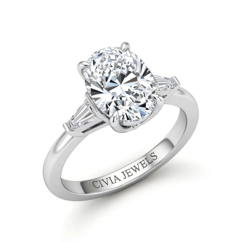 White Gold Oval Cut Three Stone Engagement Ring With Tapered Baguette Side Diamonds And Classic Four Prong Setting