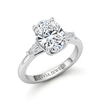 White Gold Oval Cut Three Stone Engagement Ring With Tapered Baguette Side Diamonds And Classic Four Prong Setting