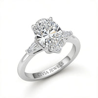 Silver Pear Cut Three Stone Engagement Ring With Tapered Baguette Side Diamonds And Classic Four Prong Setting