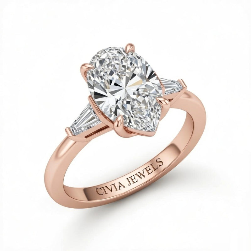 Rose Gold Pear Cut Three Stone Engagement Ring With Tapered Baguette Side Diamonds And Classic Four Prong Setting