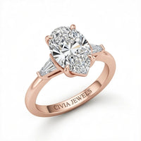 Rose Gold Pear Cut Three Stone Engagement Ring With Tapered Baguette Side Diamonds And Classic Four Prong Setting