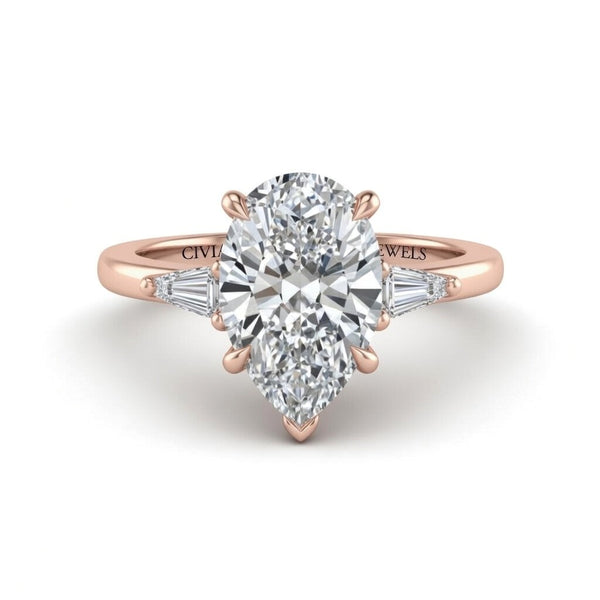 Rose Gold Pear Cut Three Stone Engagement Ring With Tapered Baguette Side Diamonds And Classic Four Prong Setting