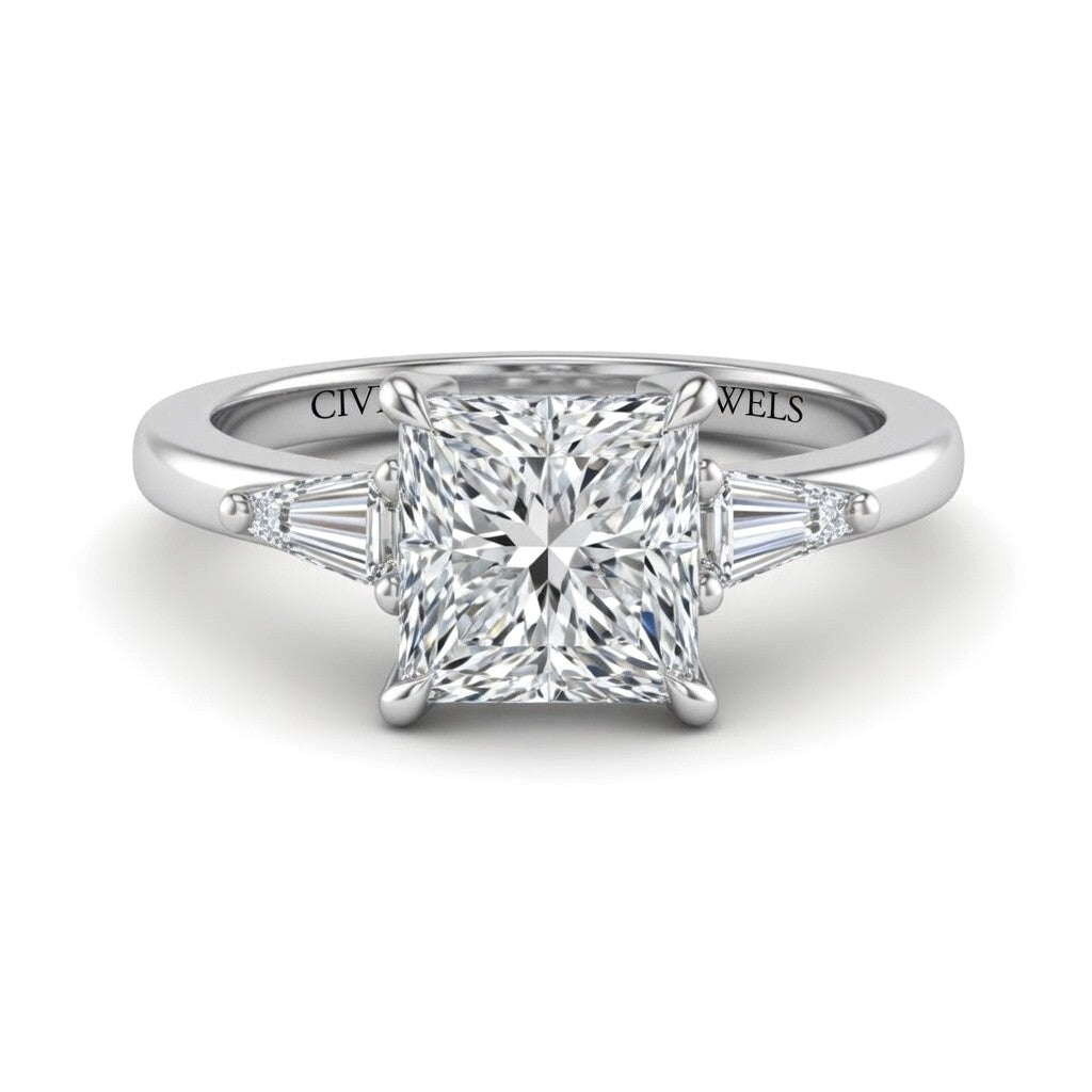 White Gold Princess Cut Three Stone Engagement Ring With Tapered Baguette Side Diamonds And Classic Four Prong Setting