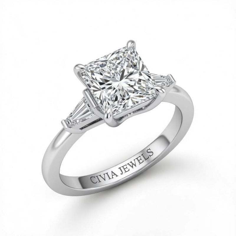 White Gold Princess Cut Three Stone Engagement Ring With Tapered Baguette Side Diamonds And Classic Four Prong Setting
