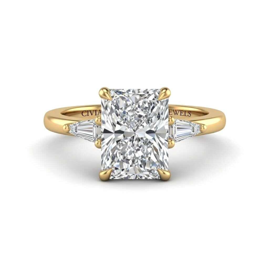 Yellow Gold Radiant Cut Three Stone Engagement Ring With Tapered Baguette Side Diamonds And Classic Four Prong Setting