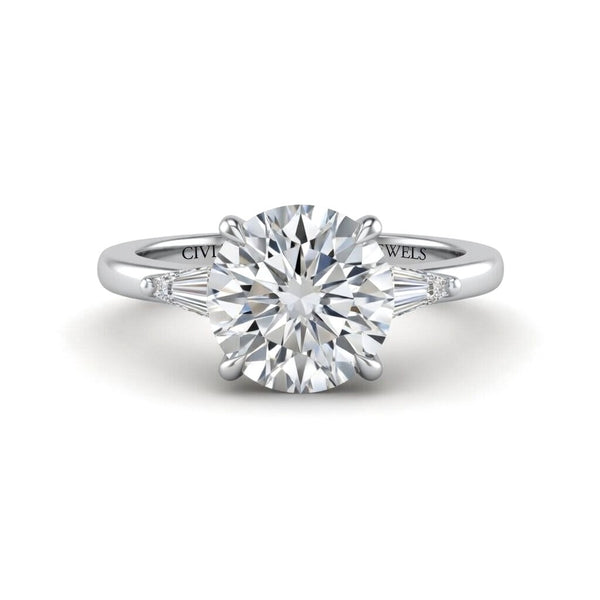 Silver Round Cut Three Stone Engagement Ring With Tapered Baguette Side Diamonds And Classic Four Prong Setting