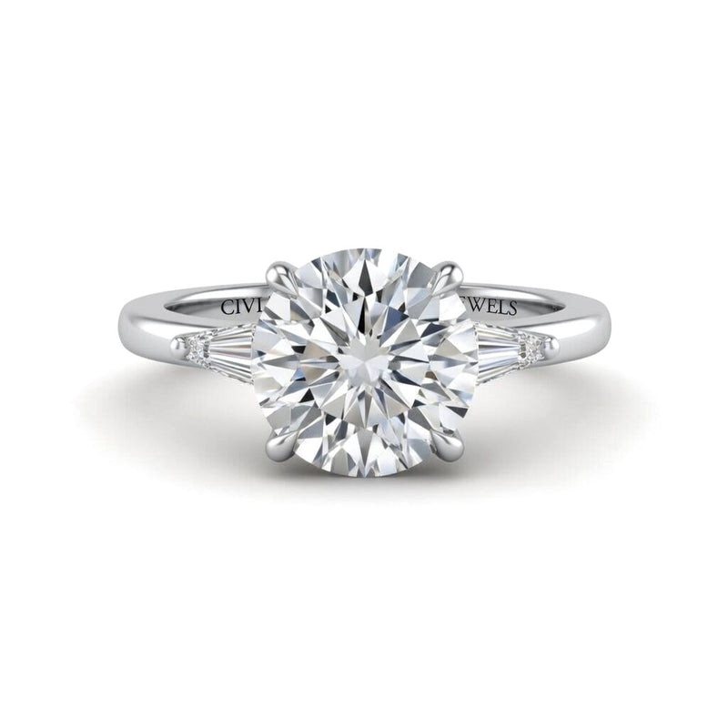 Silver Round Cut Three Stone Engagement Ring With Tapered Baguette Side Diamonds And Classic Four Prong Setting