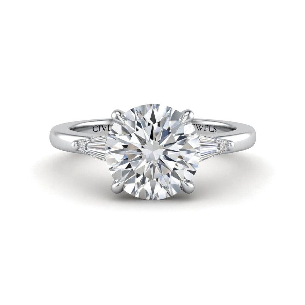 Silver Round Cut Three Stone Engagement Ring With Tapered Baguette Side Diamonds And Classic Four Prong Setting