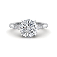 Silver Round Cut Three Stone Engagement Ring With Tapered Baguette Side Diamonds And Classic Four Prong Setting