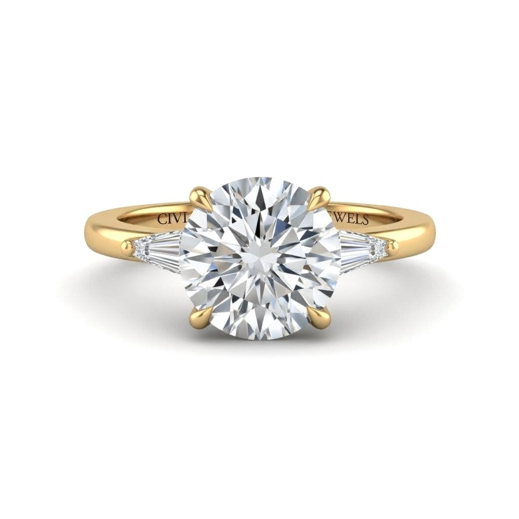 Yellow Gold Round Cut Three Stone Engagement Ring With Tapered Baguette Side Diamonds And Classic Four Prong Setting