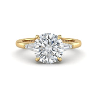 Yellow Gold Round Cut Three Stone Engagement Ring With Tapered Baguette Side Diamonds And Classic Four Prong Setting