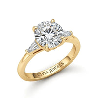 Yellow Gold Round Cut Three Stone Engagement Ring With Tapered Baguette Side Diamonds And Classic Four Prong Setting