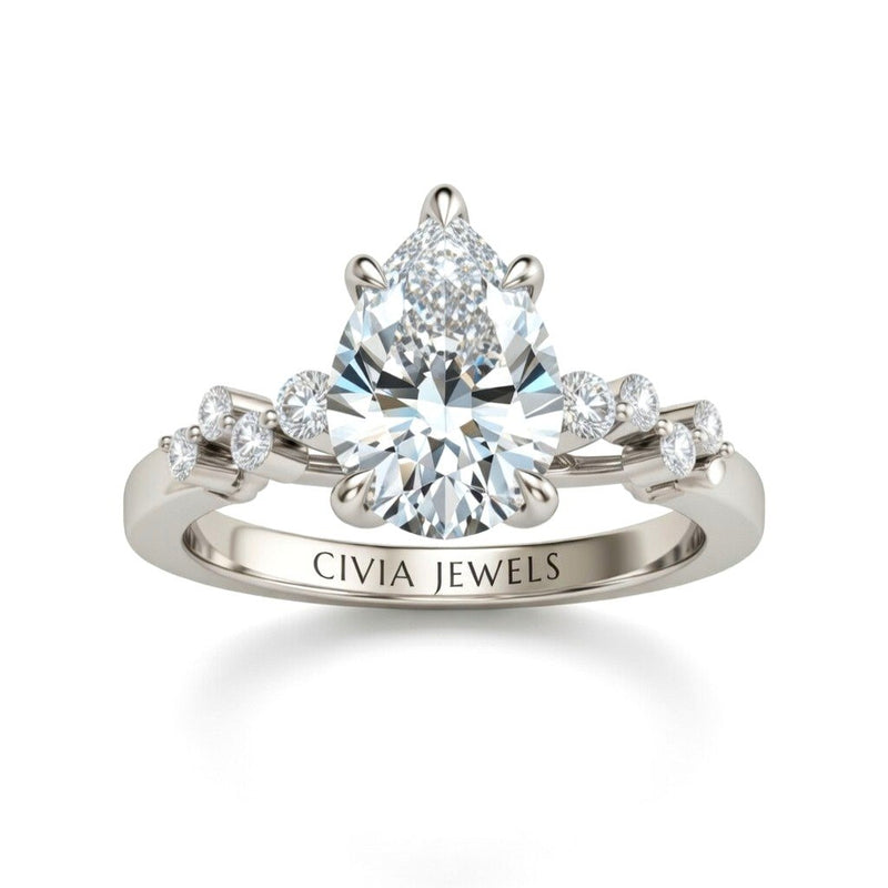 White Gold Pear Cut Engagement Ring With Diamond Scatter Accent Shoulders And Classic Four-Prong Setting