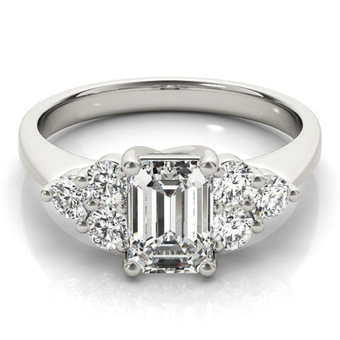 Platinum Emerald Cut Diamond Cluster Ring with Round Accent Stones and Prong Setting on a Classic Band