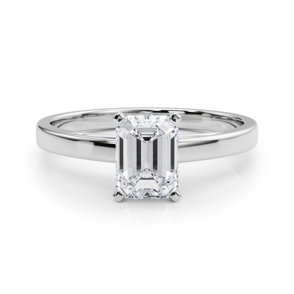 Platinum Emerald Solitaire Diamond Engagement Ring with Four-Prong Setting on a Classic Band