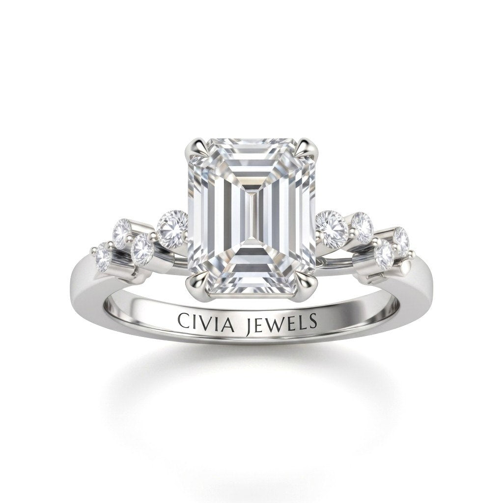 White Gold Emerald Cut Engagement Ring With Diamond Scatter Accent Shoulders And Classic Four-Prong Setting